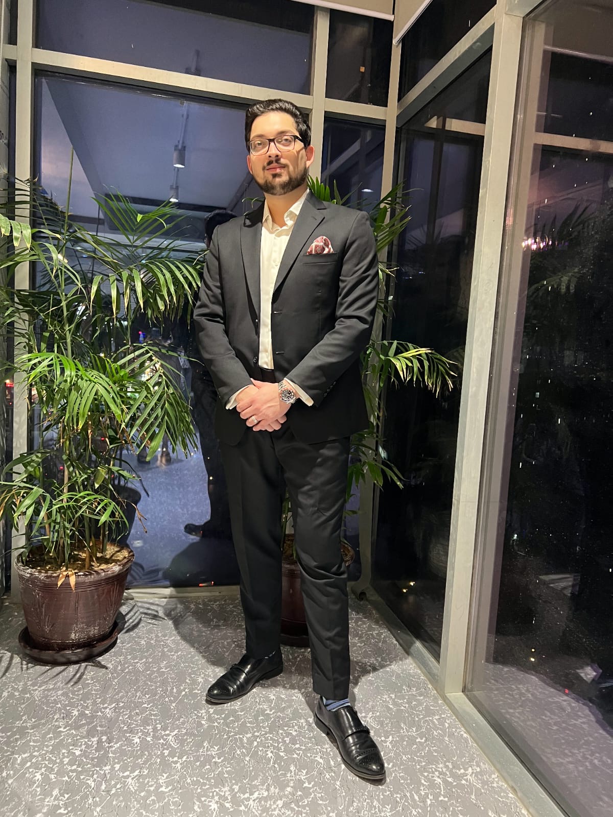 Rumman Shariq in a suit at an evening event.