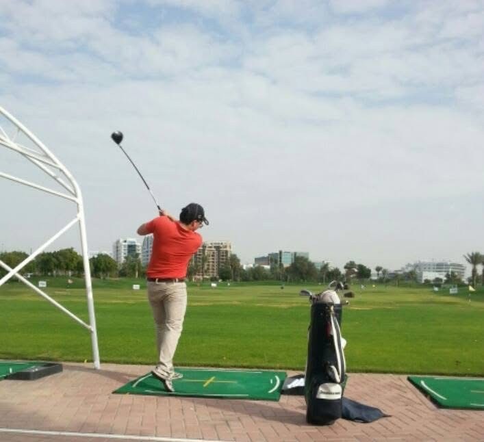 Rumman Shariq mid-swing at a driving range.